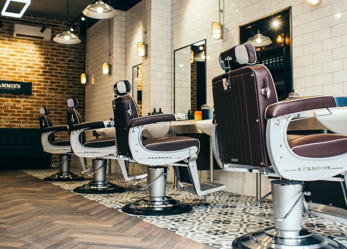 Elegant barber chairs at Sammies Studio - Fulham Road, London, England, GB showcasing modern design.