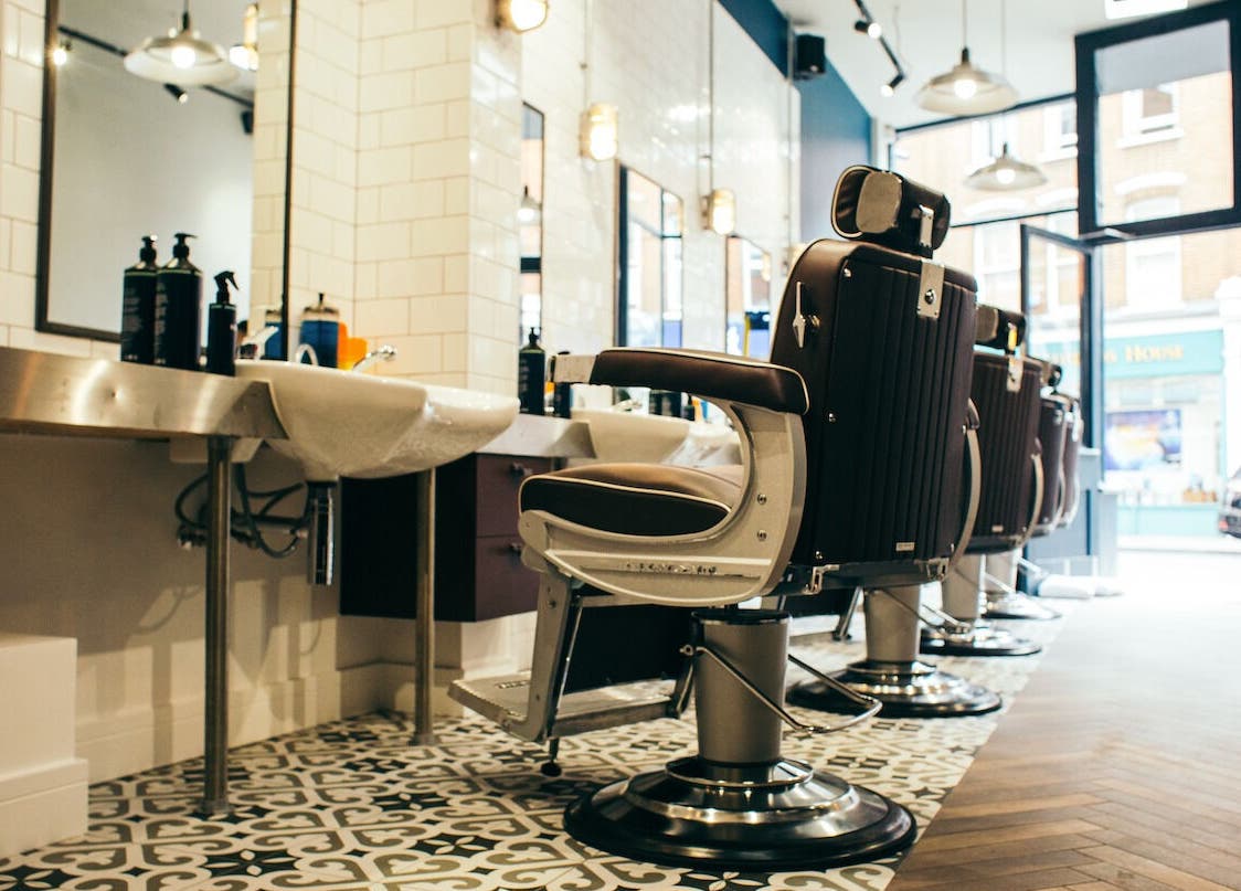 Elegant barber chairs at Sammies Studio - Fulham Road, London, England, GB showcasing modern interior.