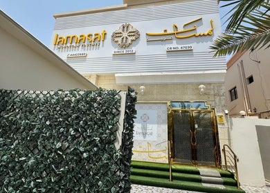 Entrance of Lamsat Magribyah Beauty Center in Doha, Al Rayyan Municipality, QA with lush greenery.