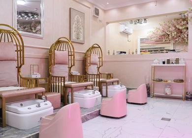 Elegant pedicure area at Lamsat Magribyah Beauty Center, Doha, Al Rayyan Municipality, QA with plush pink seating.