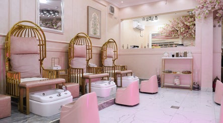 Elegant pedicure area at Lamsat Magribyah Beauty Center, Doha, Al Rayyan Municipality, QA with plush pink seating.