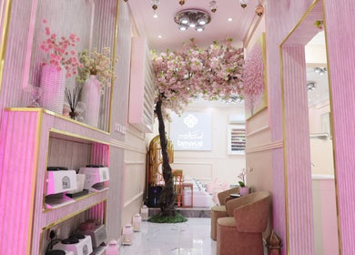 Elegant interior of Lamsat Magribyah Beauty Center, Doha, with pink decor and blossoms.