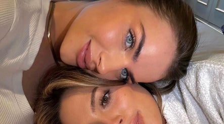 Two women smiling at SADE Aesthetics London, London, England, GB.