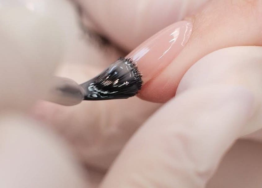 Nail polish application at Sassy Aesthetics London LTD in London, England, GB. Close-up of elegant manicure.