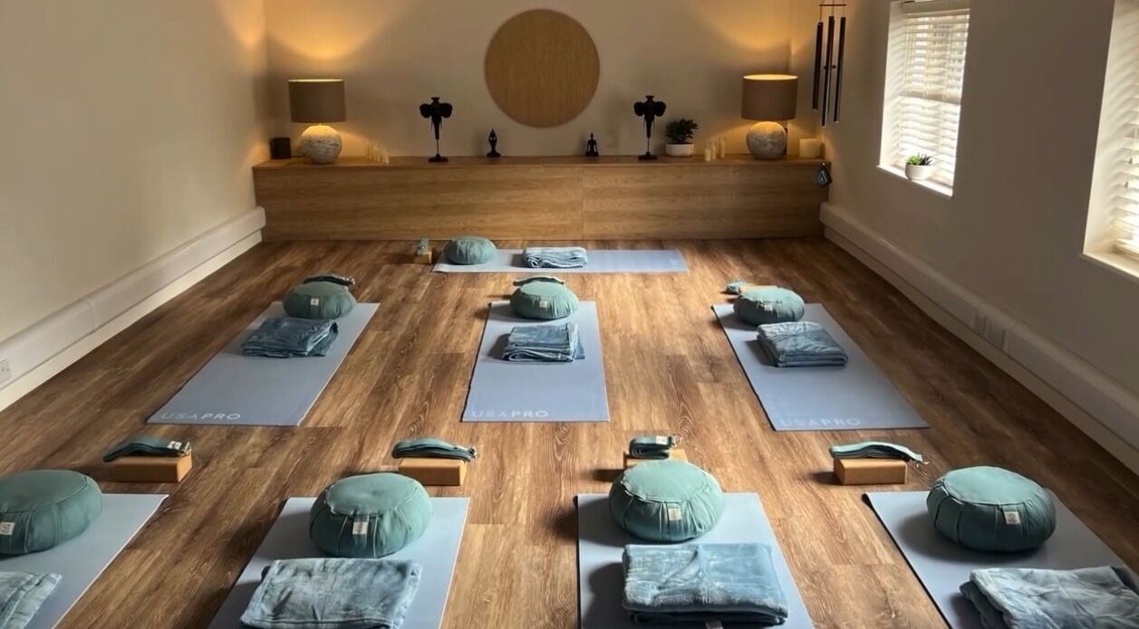 Meditation room at NOVA Wellness Clinic, Lyndhurst, England, GB, featuring yoga mats and cushions on wooden floor.