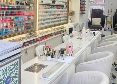 Modern nail bar at King Nails, Hampton Wick, England, GB, with elegant seating and extensive polish display.