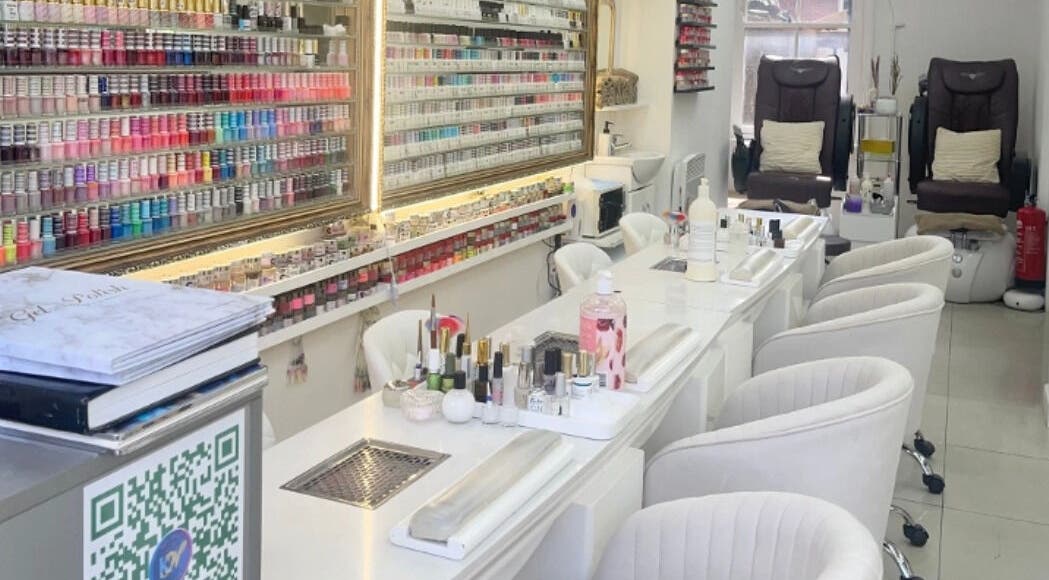 Modern nail bar at King Nails, Hampton Wick, England, GB, with elegant seating and extensive polish display.
