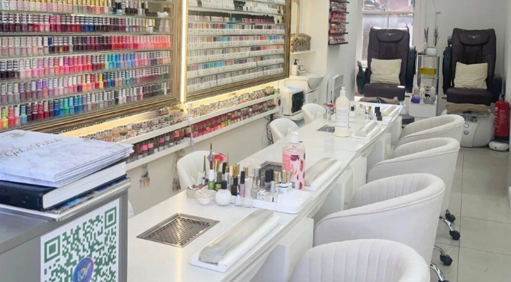 Modern nail bar at King Nails, Hampton Wick, England, GB, with elegant seating and extensive polish display.