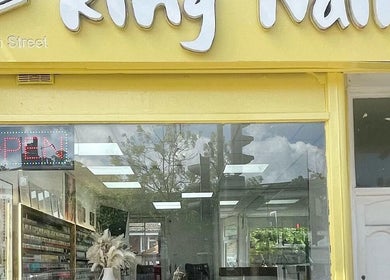 Front view of King Nails in Hampton Wick, England, GB showing the inviting yellow facade and open sign.