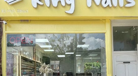Front view of King Nails in Hampton Wick, England, GB showing the inviting yellow facade and open sign.