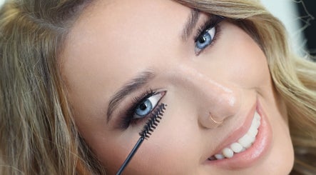 Woman applying mascara at Brynn’s Beauty Bar, Spartanburg, South Carolina, US, showcasing lash styling technique.