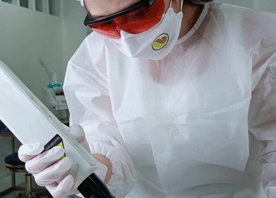 Technician performing laser treatment at Peak Beauty, Katikati, Bay Of Plenty Region, NZ.