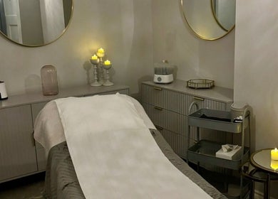 Cozy treatment room at Aura Beauty @ 68 Nail & Spa, London, England, GB, with candles and relaxing ambiance.