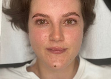 Woman with fresh brows at Aura Beauty - Oval, London, England, GB enhancing natural beauty.