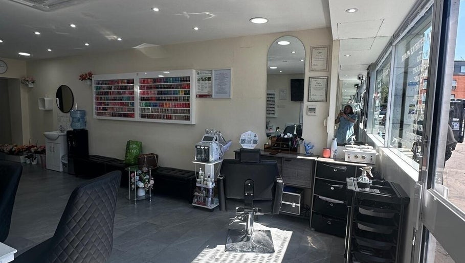 Interior of B&B M AESTHETICS AND HAIR in Southall, England, showcasing modern design and nail polish display.