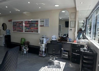 Interior of B&B M AESTHETICS AND HAIR in Southall, England, showcasing modern design and nail polish display.