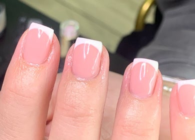 Stylish French manicure at Beautybyklw, Blackburn, England, GB showcasing glossy nails.