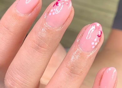 Elegant pink nail art with floral design at Beautybyklw, Blackburn, England, GB.