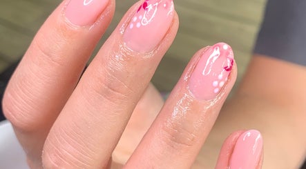 Elegant pink nail art with floral design at Beautybyklw, Blackburn, England, GB.