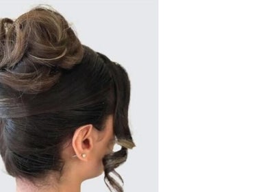 Elegant updo hairstyle by Hair Spray Home Service in Jeddah, Riyadh Province, SA, perfect for special occasions.