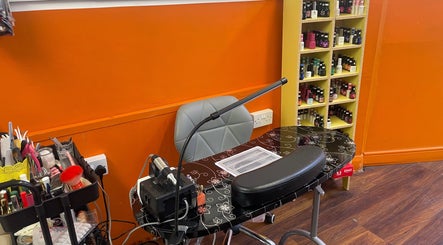 Nail station at Golden Nail in Brighton And Hove, England, GB, featuring tools and vibrant polish selection.