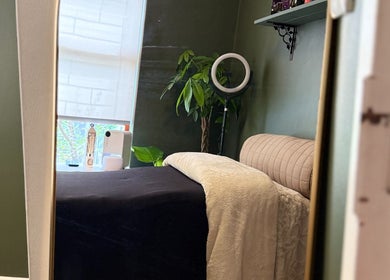 Serene treatment room at The Enchanted Wink, Cape Town, Western Cape, ZA with lush plants and soft lighting.