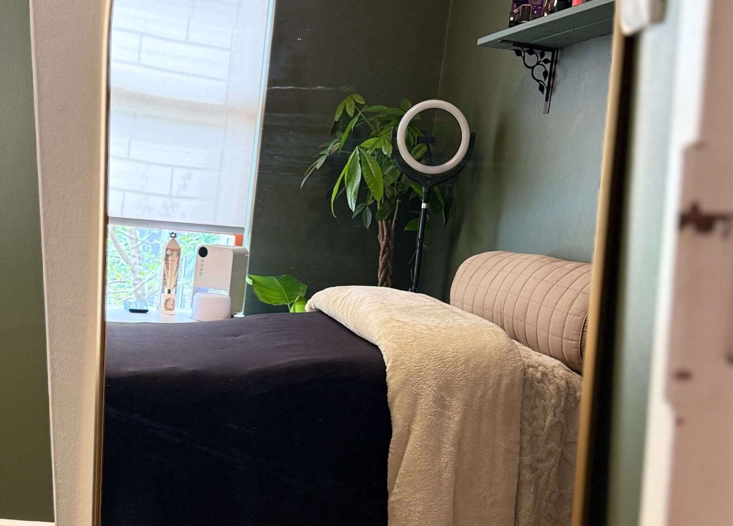 Serene treatment room at The Enchanted Wink, Cape Town, Western Cape, ZA with lush plants and soft lighting.