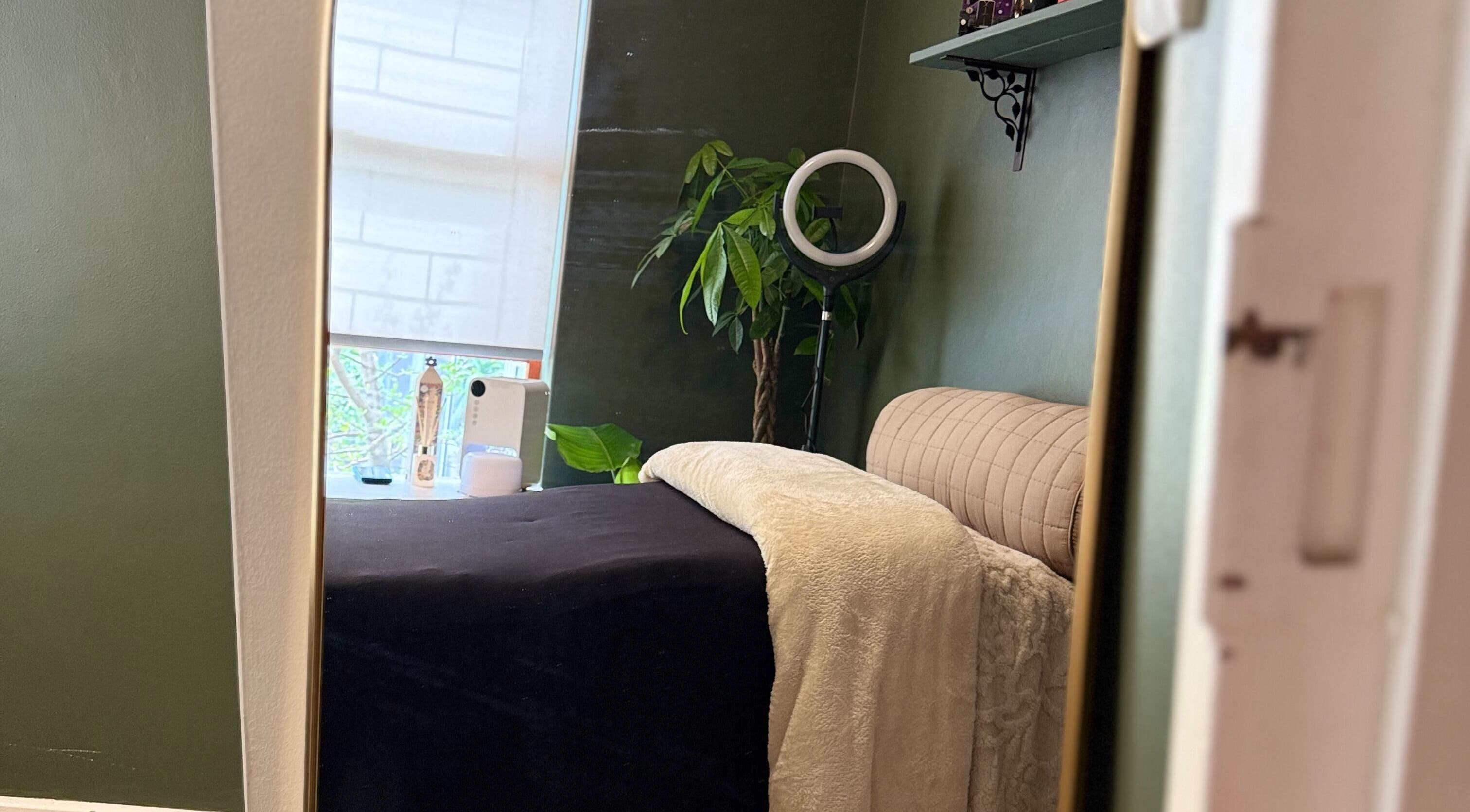 Serene treatment room at The Enchanted Wink, Cape Town, Western Cape, ZA with lush plants and soft lighting.