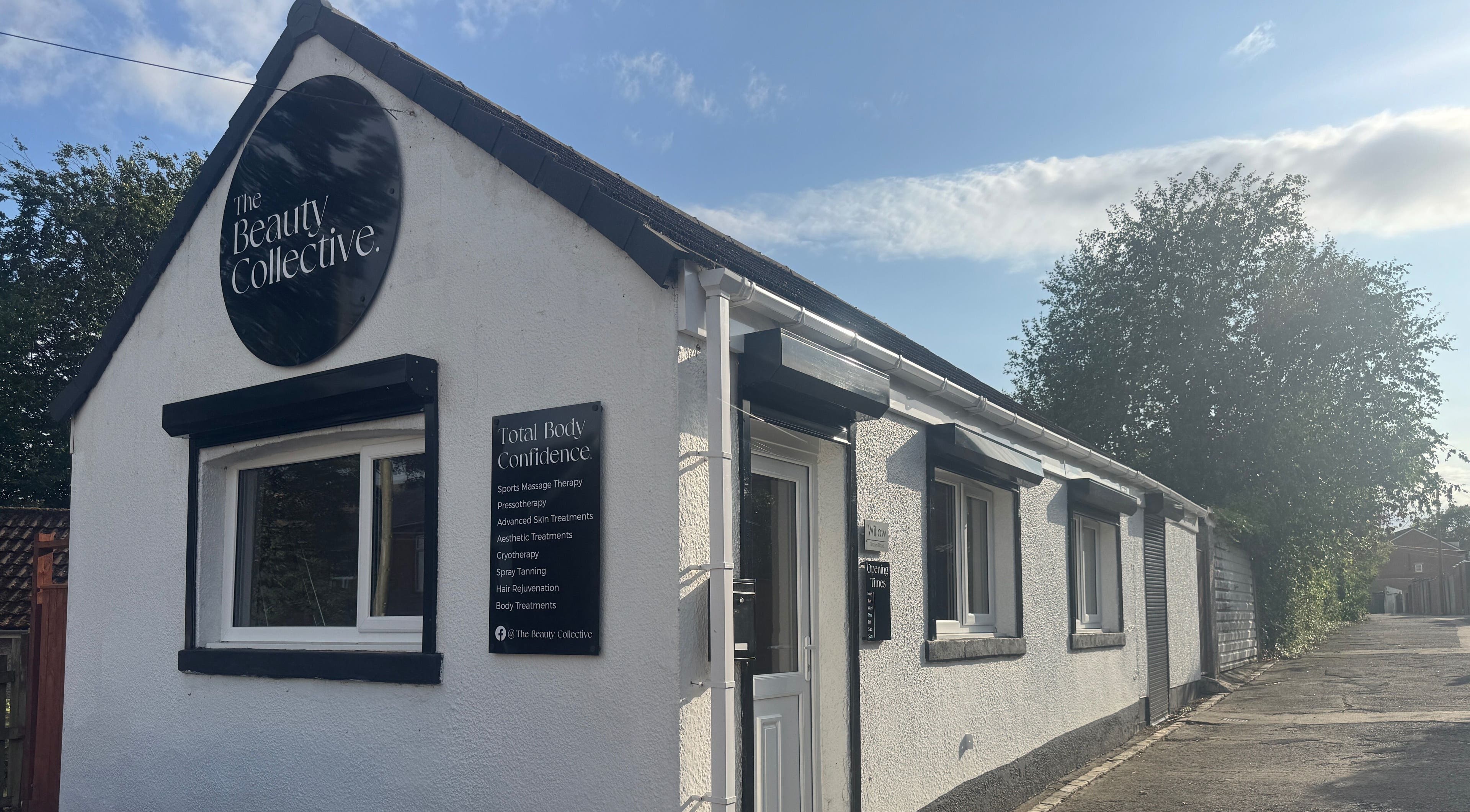 The Beauty Collective, quaint white building exterior in Ferryhill, England, GB with scenic trees.