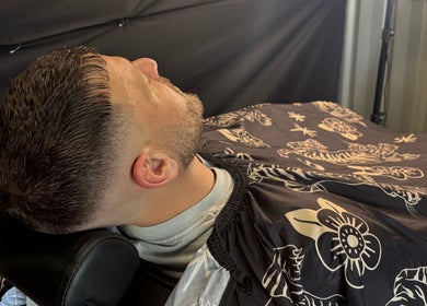 Gentleman receiving a haircut at Another Barber, Tallai, Queensland, AU, showcasing a stylish modern buzz cut.