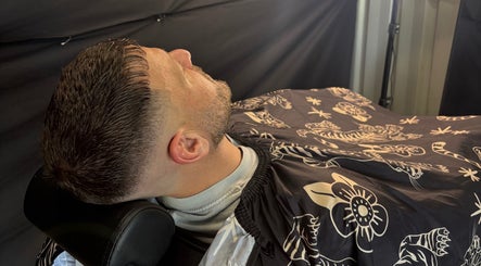 Gentleman receiving a haircut at Another Barber, Tallai, Queensland, AU, showcasing a stylish modern buzz cut.