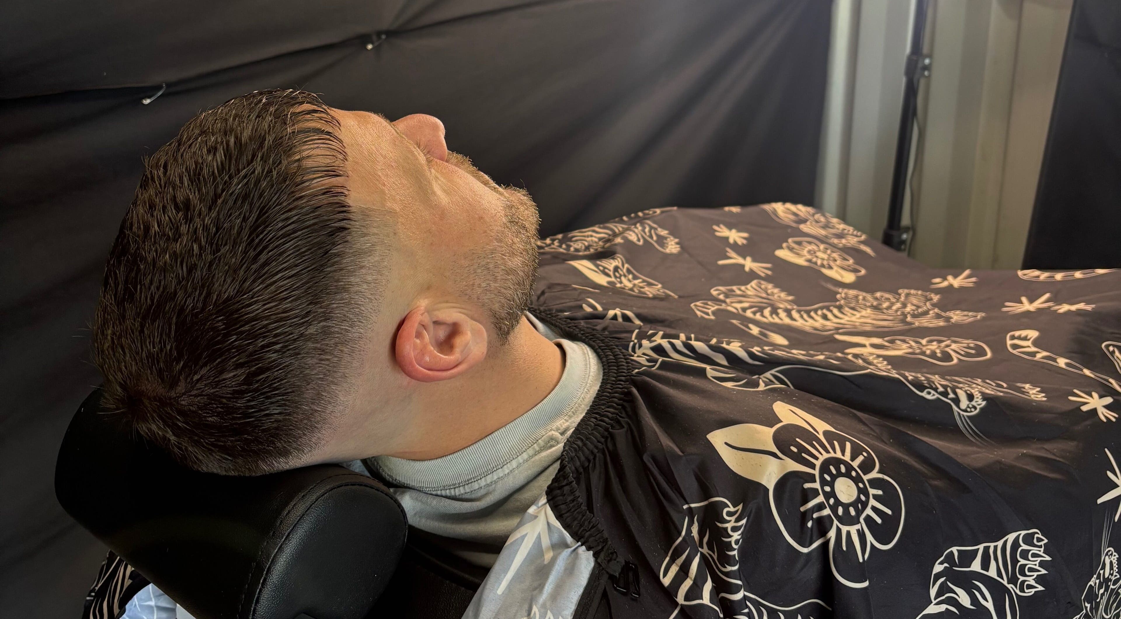 Gentleman receiving a haircut at Another Barber, Tallai, Queensland, AU, showcasing a stylish modern buzz cut.