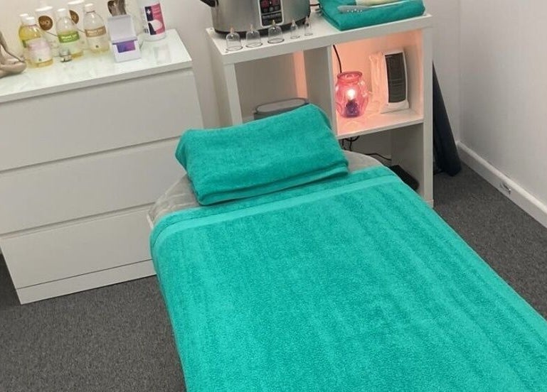 Relaxing massage room at The House Of Calm, South Shields, England, GB, featuring a teal towel and serene decor.