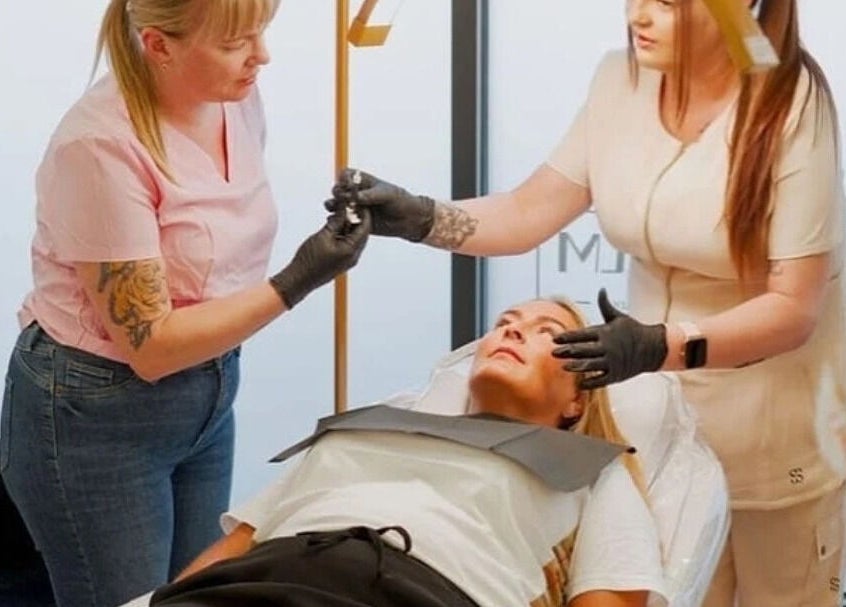 Relaxing treatment at The House Of Calm in South Shields, England, GB. Two professionals attending to a client.