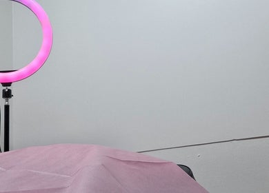 Cozy treatment room at Glow & Go, Paramaribo, Paramaribo, SR with pink ring light ambiance.
