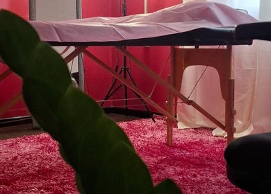 Cozy treatment room at Glow & Go, Paramaribo, Paramaribo, SR, featuring a massage table and pink decor.