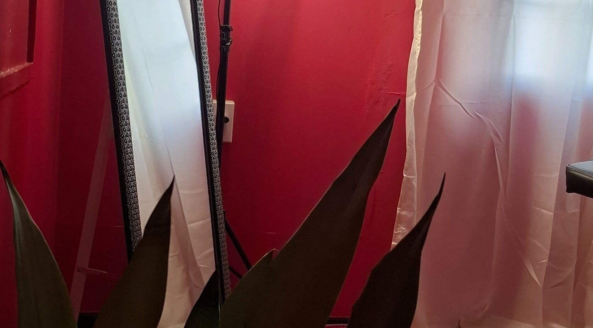 Elegant mirror with a red backdrop at Glow & Go, Paramaribo, Paramaribo, SR.