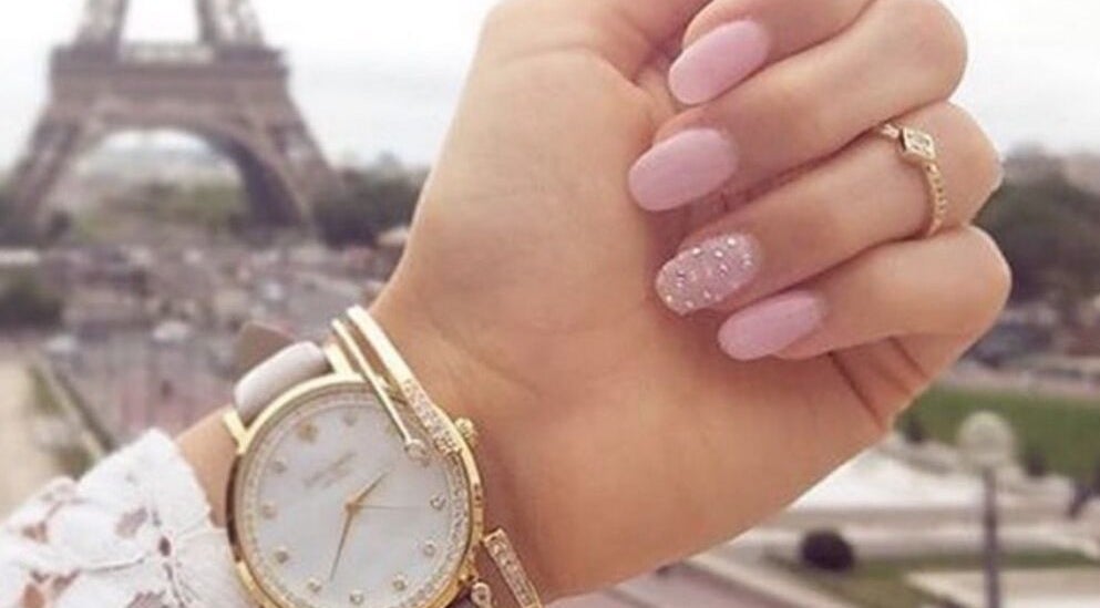 Stylish pink manicure with a watch at Narineh in Burbank, California, US, showcasing elegance and beauty.