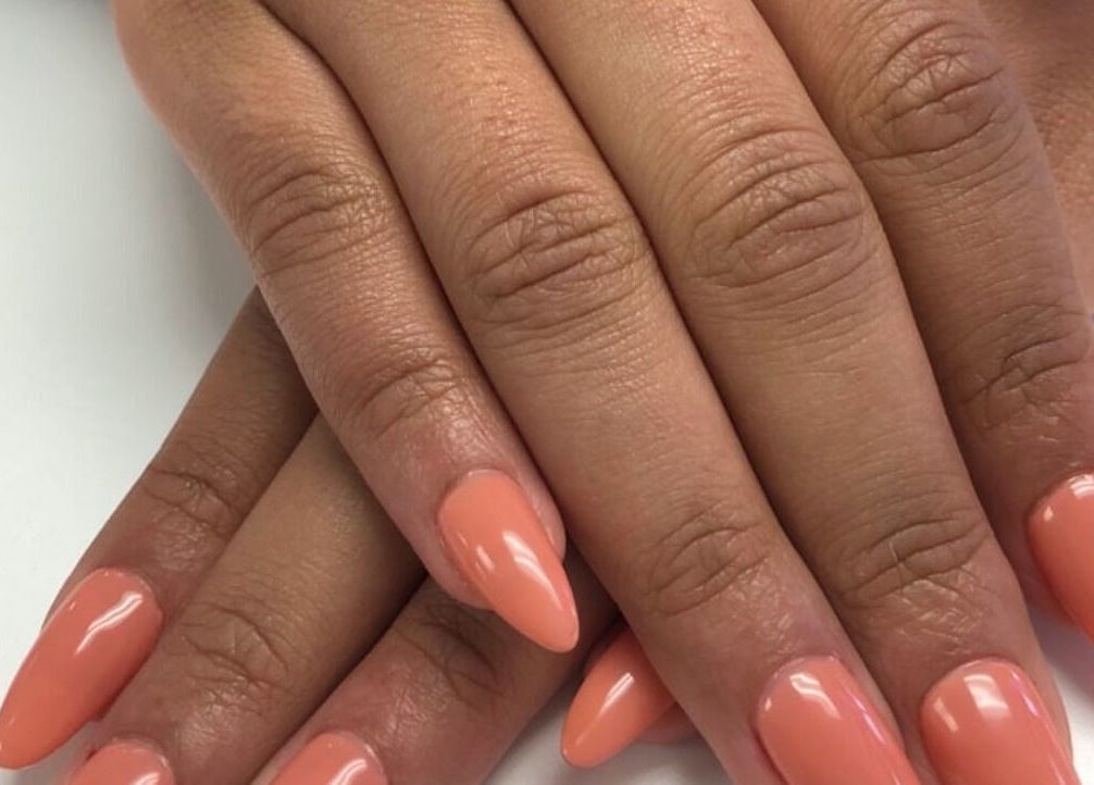 Elegant peach manicure at Narineh in Burbank, California, US showcasing glossy, pointed nails.