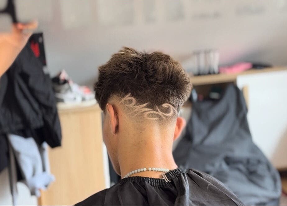 Intricate hair design at TomasCutzz_, Český Krumlov, Jihočeský Kraj, CZ. Back view of stylish undercut.