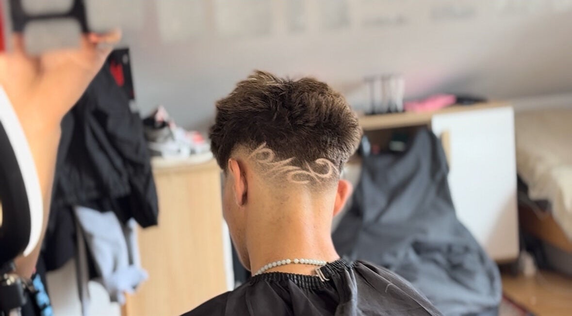 Intricate hair design at TomasCutzz_, Český Krumlov, Jihočeský Kraj, CZ. Back view of stylish undercut.