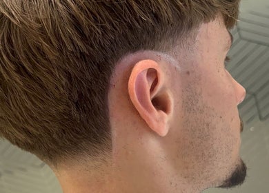 Close-up of a stylish modern taper haircut at Level Up Barbershop, Manchester, England, GB.