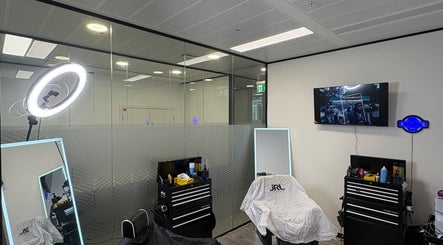 Modern barber station at Level Up Barbershop, Manchester, England, GB with ring light, mirrors, and TV screen.