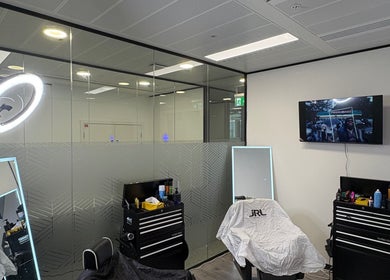 Modern barber setup at Level Up Barbershop, Manchester, England, GB with sleek tools and stylish decor.