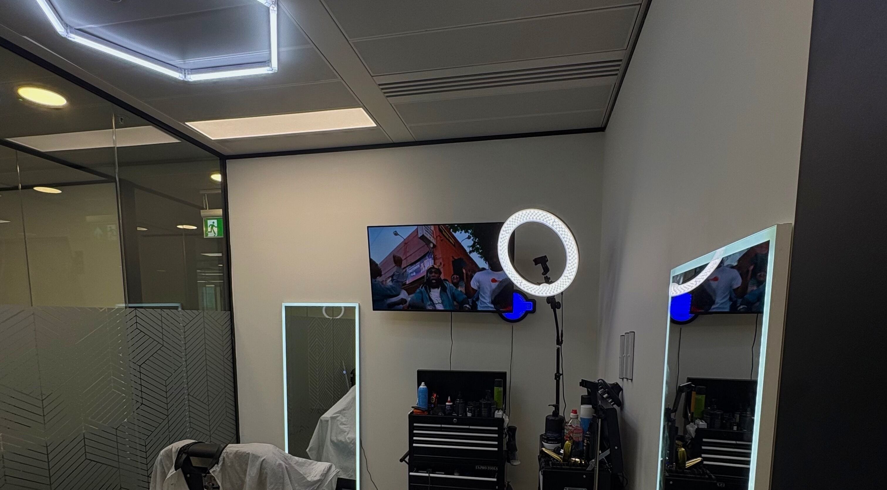 Modern interior of Level Up Barbershop in Manchester, England, GB with stylish lighting and grooming tools.