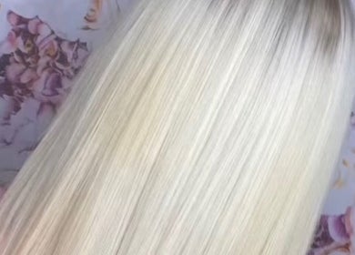 Sleek, blonde hair styled at PureGold Beauty in Skelton-in-cleveland, England, GB against floral backdrop.