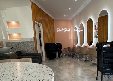 Modern salon interior at LYS THE STUDIO, Gold Coast, Queensland, AU with stylish chairs and lighted mirrors.