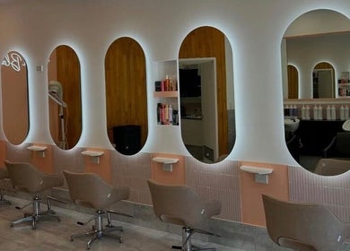 Chic hair stations at LYS THE STUDIO, Gold Coast, Queensland, AU with stylish seating and illuminated mirrors.