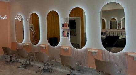 Chic hair stations at LYS THE STUDIO, Gold Coast, Queensland, AU with stylish seating and illuminated mirrors.
