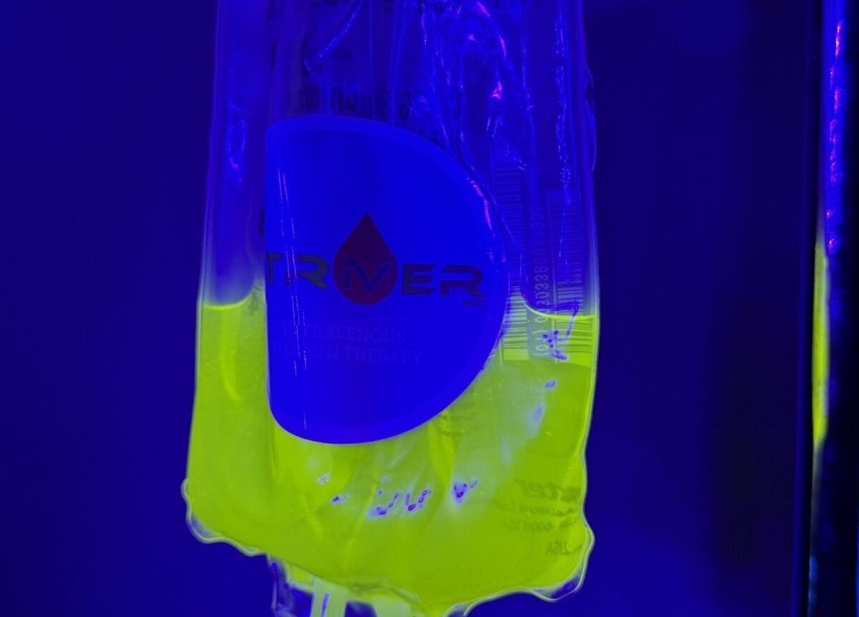 Vibrant IV bag at Striver IV Vitamin Infusion, Chicago, Illinois, US under blue light.